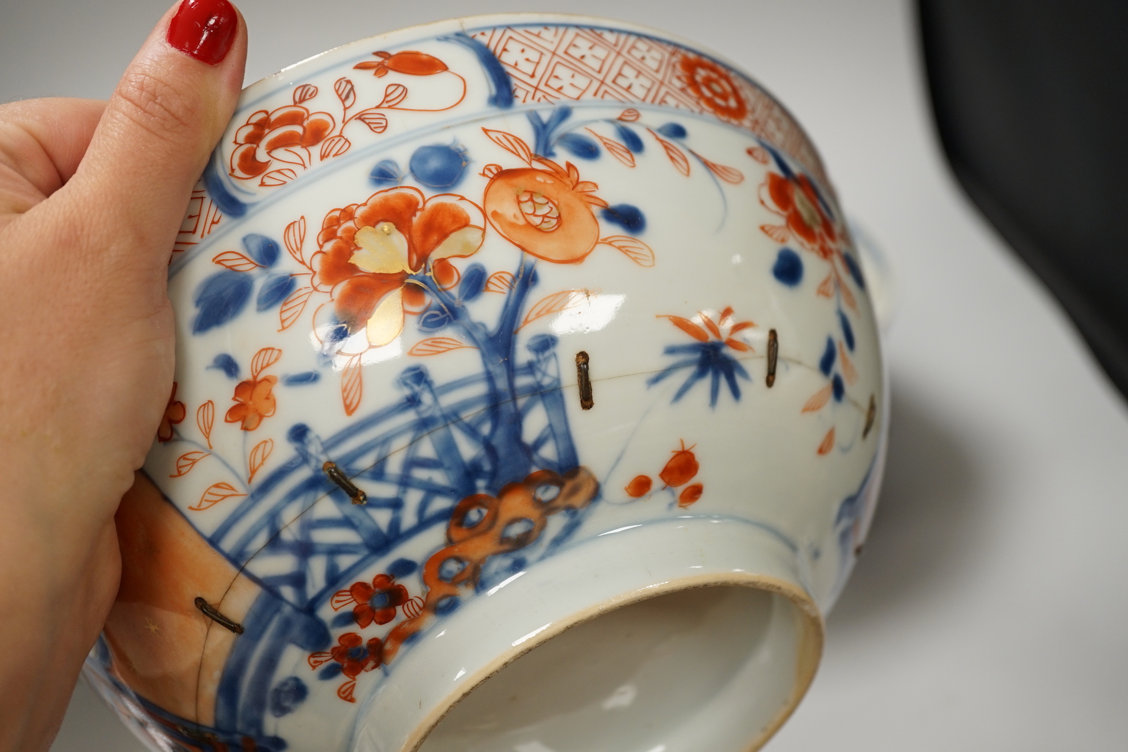 Four 18th century Chinese porcelain bowls (a.f), one with hardwood stand, largest 28cm diameter
